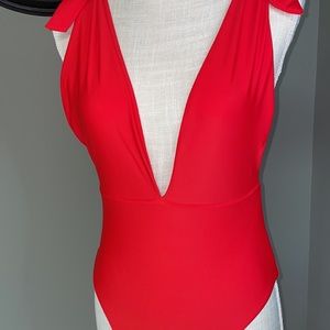 Beautiful sexy size medium swimsuit. Color is red/orange in color but more red.
